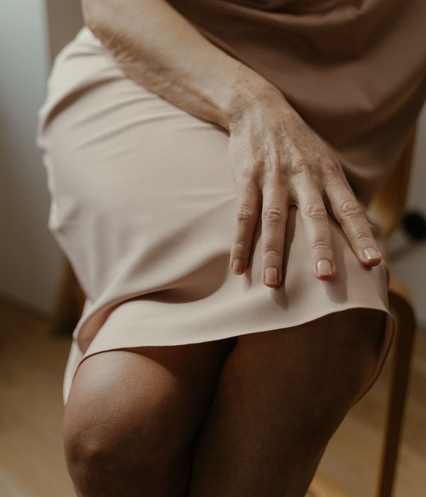 Woman in a graceful yoga pose with sunblush pink light accents.